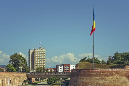 Alba Iulia, Romania - July 24, 2016: The Romanian flag raised in front of  the Alba Carolina western entrance, a Vauban bastion fortress built between 1715-1738.のeditorial素材