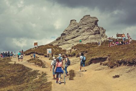 Bucegi Mountains, Romania - August 6, 2016: Hundreds of people hike the trails to the Sphinx, the...