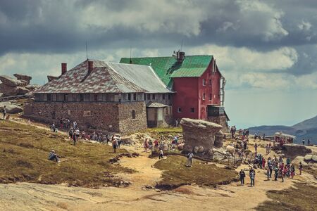 Bucegi Mountains, Romania - August 6, 2016: Thousands of tourists hike the trails to the Babele (The Old Women) chalet at 2206 m altitude in Bucegi Mountains to visit the Babele Rocks and the Sphinx.のeditorial素材