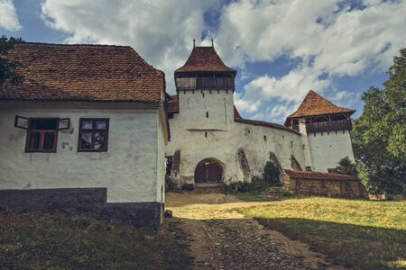 Viscri, Romania - July 21, 2016: Southeast wall and the main entrance of the Viscri fortified church,  Villages with Fortified Churches in Transylvania.のeditorial素材