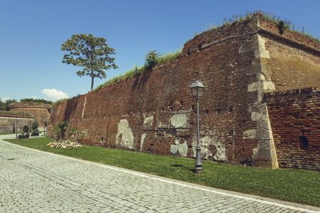 Majestic ruins of brick fortification walls and cobblestone alley of the spectacular medieval strategic fortress of White Carolina Citadel.の写真素材