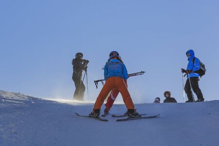 Poiana Brasov, Romania - January 1, 2017: Woman ski instructor teaches tourists to slide down the ski slopes in Postavaru Mountain, Poiana Brasov, the most appreciated Romanian winter resort.のeditorial素材