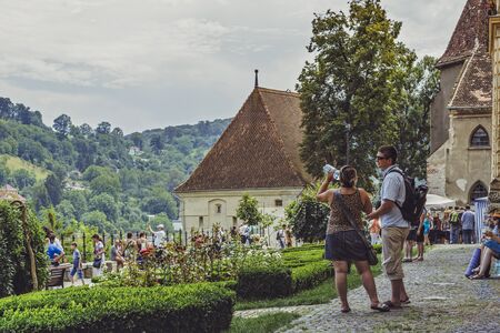 Sighisoara, Romania - July 26, 2014: Tourists relax and enjoy the sights at the famous medieval citadel of Sighisoara, one of the few still inhabited citadels in Europeのeditorial素材