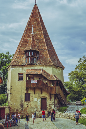 Sighisoara, Romania - July 26, 2014: Tourists visit the old Cobblers' Tower (Turnul Cizmarilor), first mentioned in 1521, rebuilt in 1681 in the north-east of the medieval citadel of Sighisoara.のeditorial素材