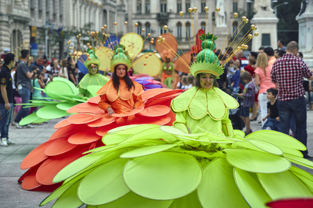 Bucharest, Romania - May 29, 2014: Female dancers in large exotic colorful costumes present The Giant Flowers show during the B-Fit International Street Theater Festival in the historic center.のeditorial素材