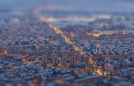 Aerial view of a residential district illuminated at twilight during winter, Brasov, Romania. Tilt-shift blur effect.の写真素材
