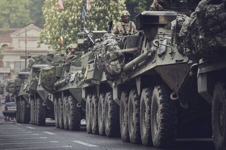 Brasov, Romania - May 14, 2015: American convoy of troops and wheeled armored vehicles march through Brasov city on their way to Cincu to take part in an international military exercise.のeditorial素材