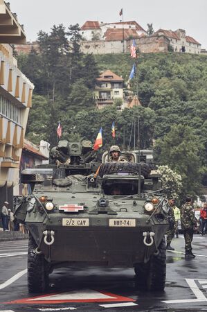 Brasov, Romania - May 14, 2015: American convoy of troops and heavy armored vehicles march through Brasov city on their way to Cincu to take part in an international drill.のeditorial素材