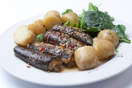 Roasted Sardines garnished with chilli and garlicの写真素材