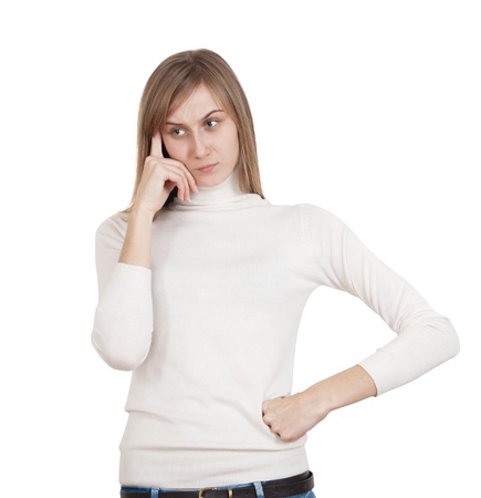 sad young girl in white sweater hand to face thoughtの写真素材