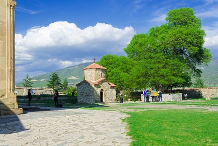 tourists are looking around the monastery of mothers which is one of the sights of Georgia. 