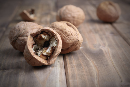pile of walnuts on an old wooden tableの写真素材