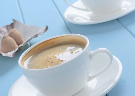 cup of espresso coffee and chocolate truffles on the tableの写真素材