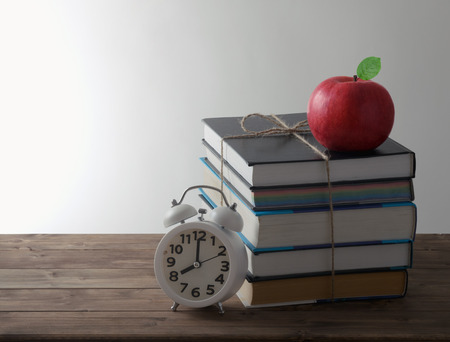 set of books with alarm and red Apple education conceptの写真素材