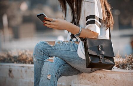 teenage  girl reading a message on your phoneの写真素材