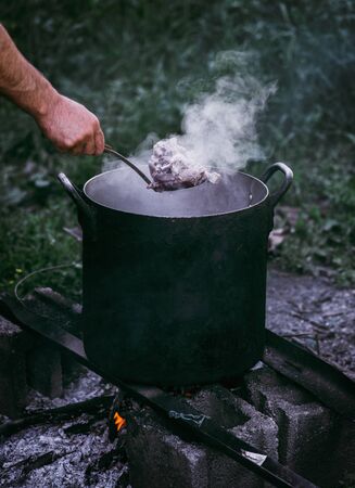 Hot boiled meat, cooking beef at the stakeの写真素材