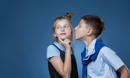 the guy kisses the girl on the cheek, the girl is embarrassedの写真素材