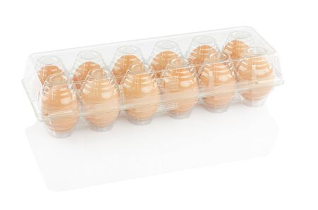 chicken eggs in a plastic container isolated on a white background, clipping pathの写真素材