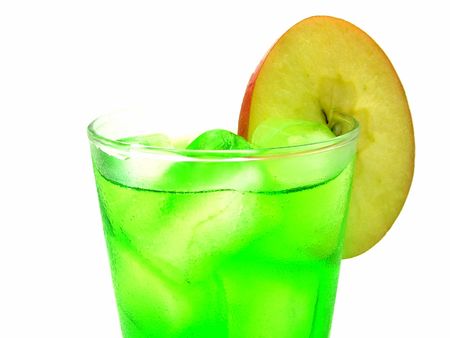 A cool green drink with ice and a slice of appleの写真素材