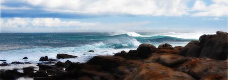 Wild surfing scene with wind-driven sea spray near a coastlineの写真素材