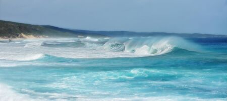 Wild surfing scene with wind-driven sea spray near a coastlineの写真素材