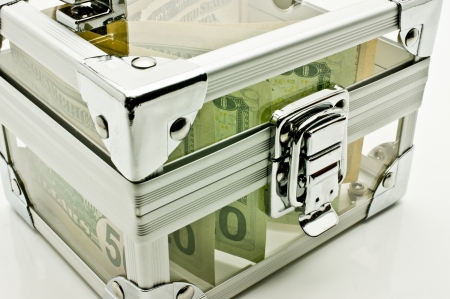 Dollars in a transparent box with a lockの写真素材