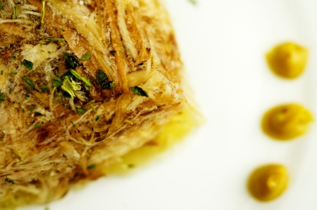 Jellied, aspic cooked from beef, pork, chicken with mustard on a plate close-up.