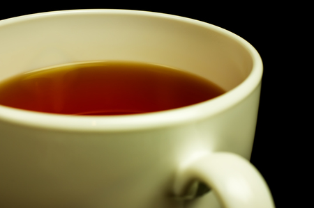 White cup of tea on a black background. Close-up.の写真素材