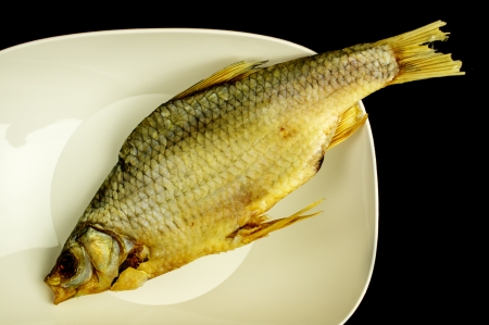 Dried fish in a white cup on a black background. Close-up.の写真素材