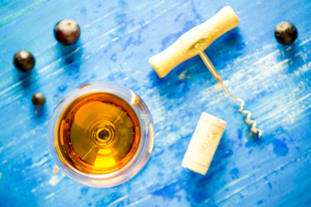 Wine glass, a corkscrew, cork and grapes. top viewの写真素材