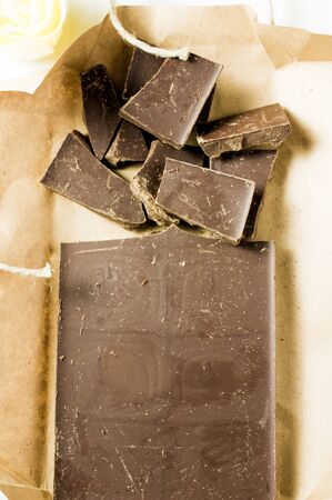 Chocolate bar in an open box with pieces
