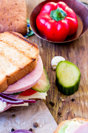 Sandwich with ham, cheese, lettuce and picklesの写真素材