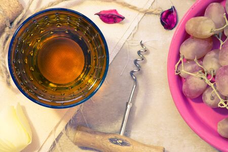 Glass of white wine with grapesの写真素材