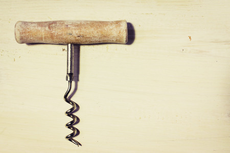Vintage corkscrew on the old board for backgroundの写真素材