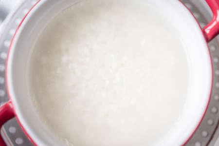 Rice in a saucepan on the stove to cook