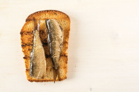 Sandwich with sardines on white wooden table and space for textの写真素材