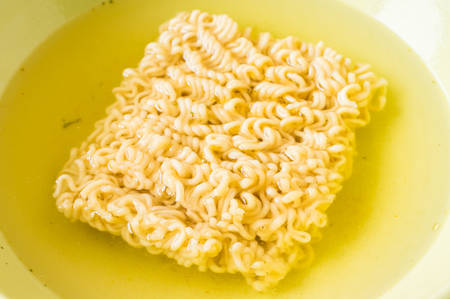 Instant noodle soup brewed with meat, vegetables and spicesの写真素材