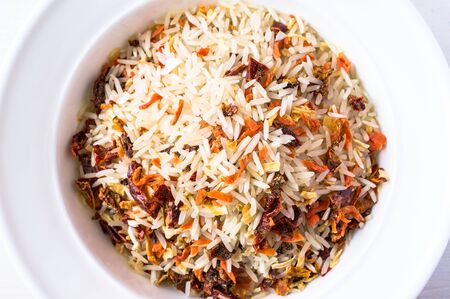 Rice with vegetables on the plate top view
