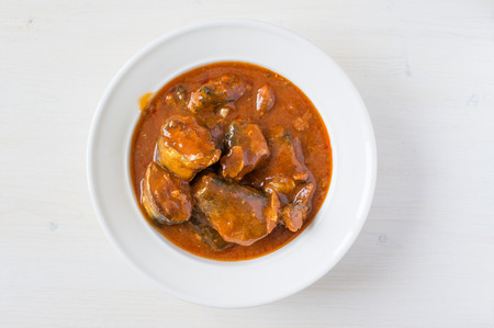 Canned fish in tomato sauce on the plate top viewの写真素材