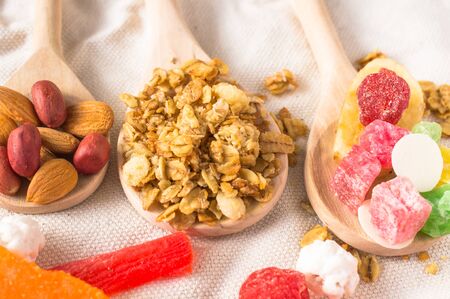 Muesli with fruit and nuts in a wooden spoon for backgroundの写真素材