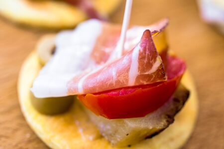 Tapas with bacon and potatoes, olives and tomatoesの写真素材