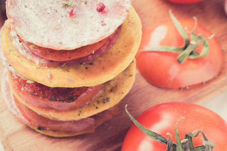 Tapas with tomato, eggplant and sausage with spices. Pastel color filter.の写真素材