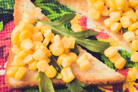 Tapas toast fried with sweet corn and arugulaの写真素材