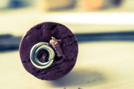 Pierced cork corkscrew red wine through