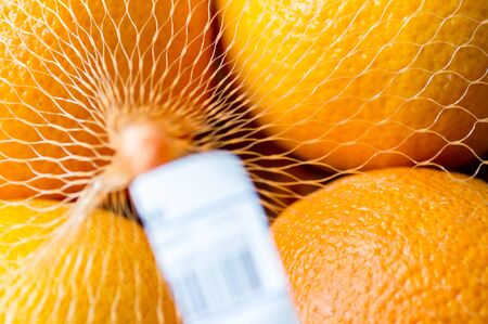 Oranges in the package at the supermarket. Barcode blurredの写真素材