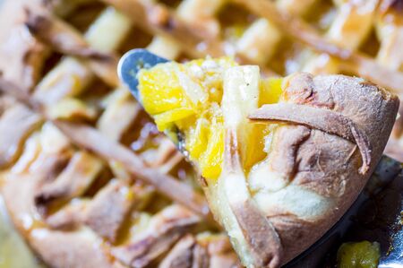 Scapula with a slice of orange pie top viewの写真素材