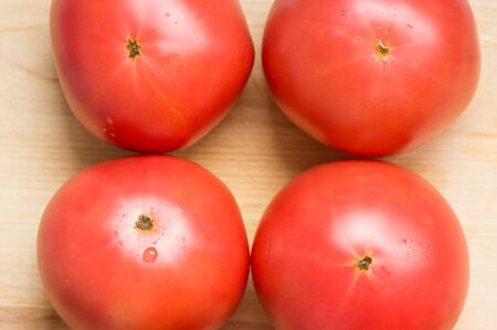 Four large tomatoes top viewの写真素材