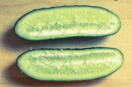 Halved cucumber with salt top viewの写真素材
