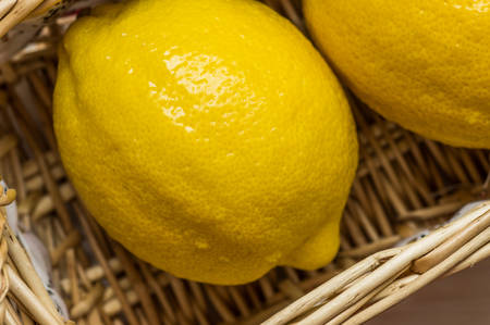 Fresh lemons in a basket top viewの写真素材