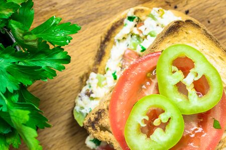 Peppers and tomatoes with parsley on the sandwich top viewの写真素材